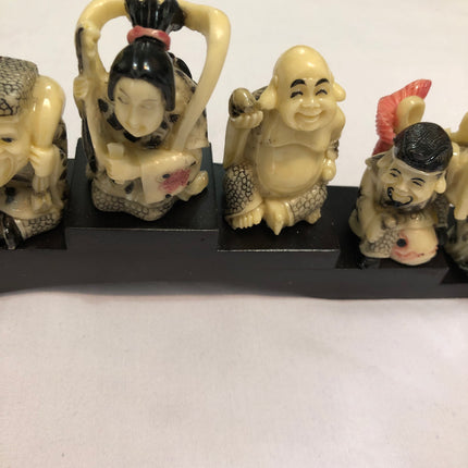 Seven Oriental Figurines On A Stand.
