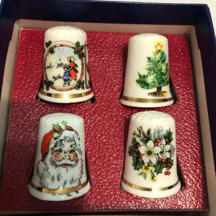 A Collection Of Four Fine China Christmas Thimbles.