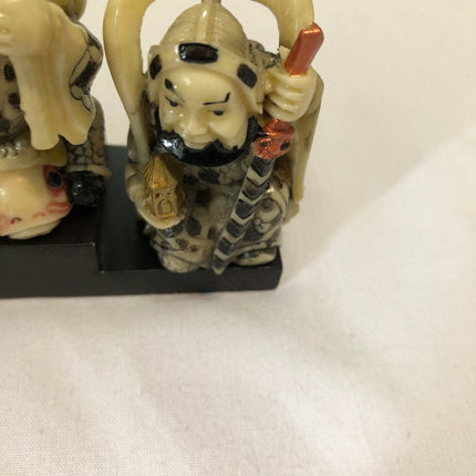 Seven Oriental Figurines On A Stand.