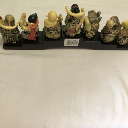 Seven Oriental Figurines On A Stand.